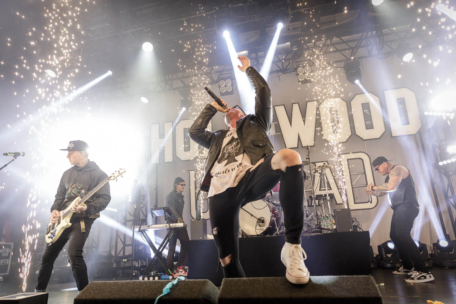 Hollywood Undead performing live with electric guitars on stage